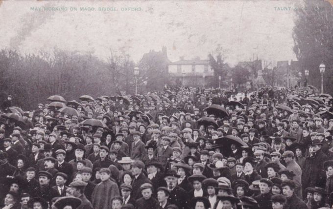 A Henry Taunt postcard of 1908 shows May Morning on Magdalen Bridge. The reverse suggests that vendors were out in the early hours selling postcards to the crowd (see below).