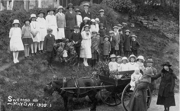 May Day at Swerford, 1922; you can just see a 'lady' hanging in the garland held by the children on the slope. In Swerford, garlands were carried round the village in pony carts. Thanks to Margaret Chaplin for this image.